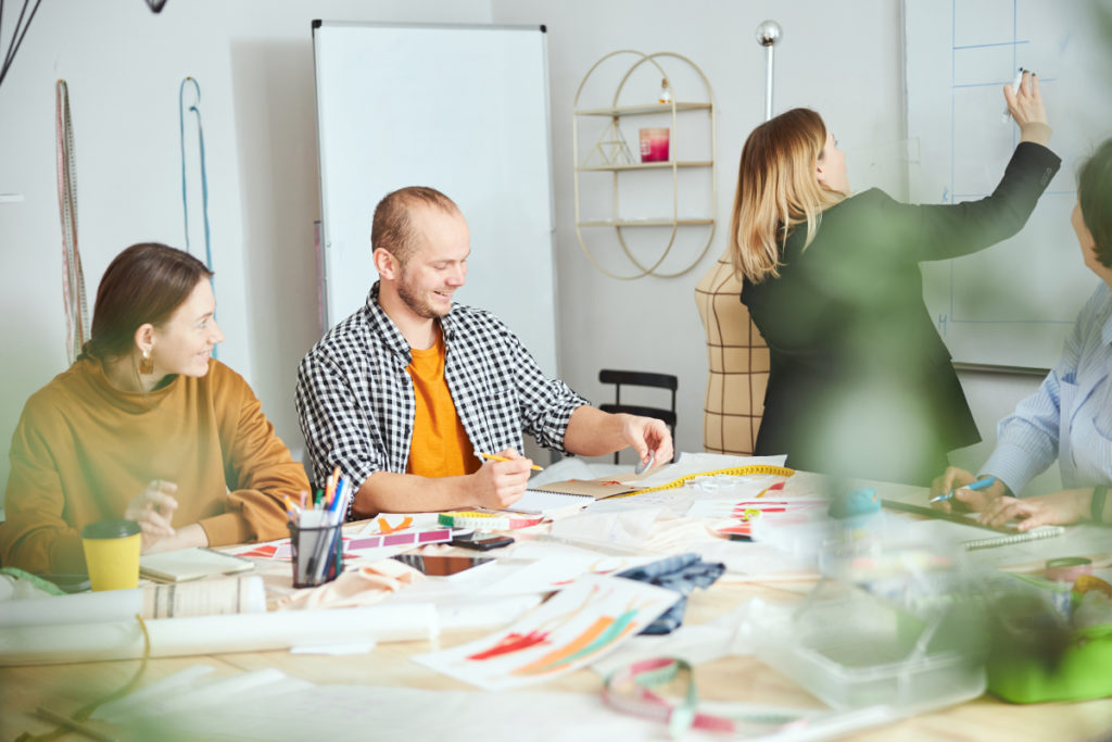 group of people gathered in a conference room planning their marketing