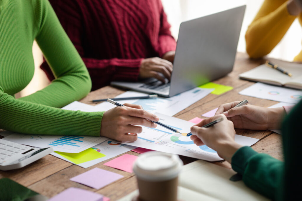 Group of professionals seated around a table working on a marketing strategy