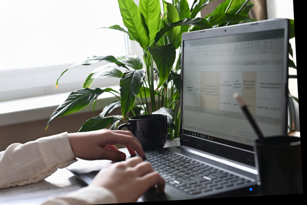 person working at a computer to write monthly content for social media