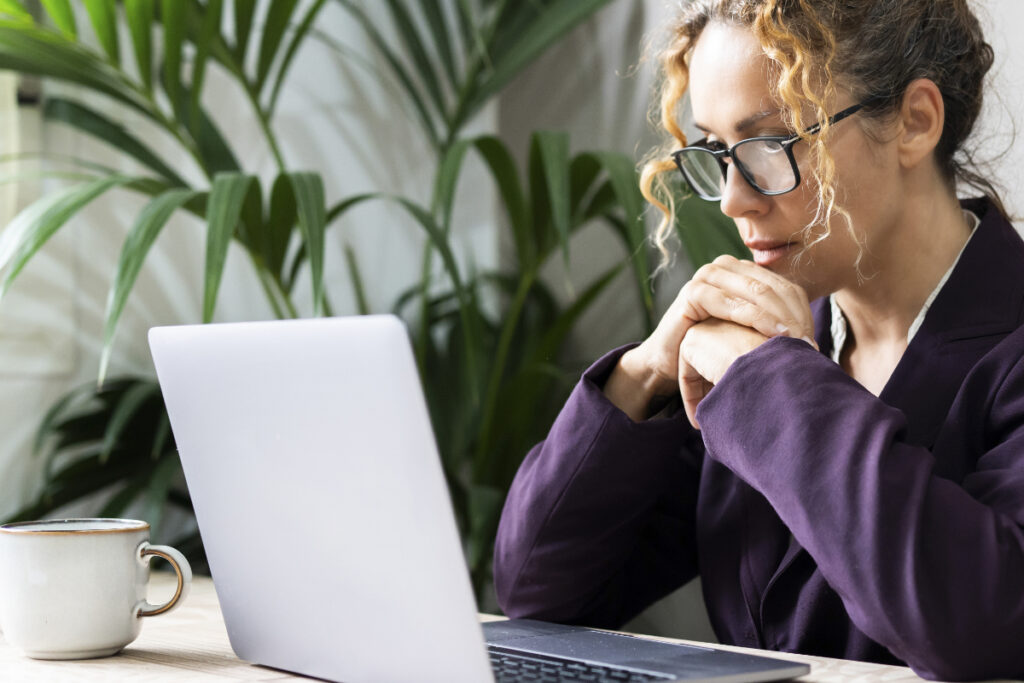 woman working on a laptop to write website copy