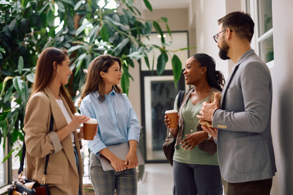 A group of professionals engaging in a conversation, highlighting the power of word-of-mouth marketing through networking.